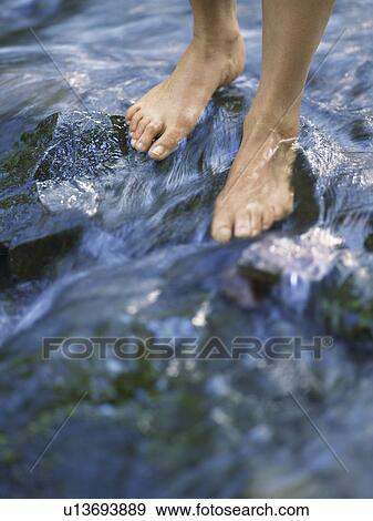 Feet walking on river rocks View Large Photo Image Stock Photo - Feet walking on river rocks. Fotosearch