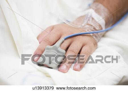 Stock Photo - Finger heart monitor on hospital patient. Fotosearch