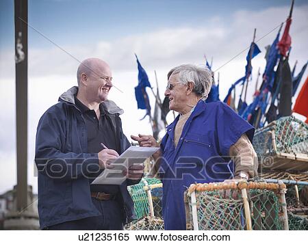 Stock Photography - Fish inspector talking with fisherman. Fotosearch