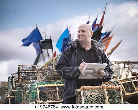 Picture - Fish inspector with lobster pots. Fotosearch