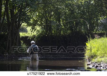 Fly fisherman casting a line in river View Large Photo Image Stock Image - Fly fisherman casting a line in river. Fotosearch