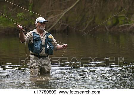 Fly fisherman casting a line in river View Large Photo Image Stock Photo - Fly fisherman casting a line in river. Fotosearch