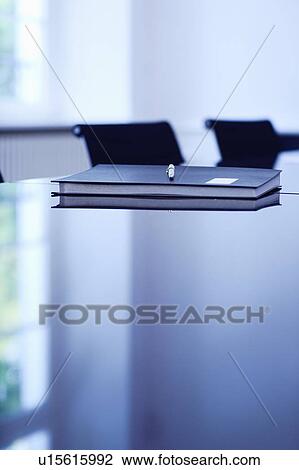 Stock Image - Folder and pen on office desk. Fotosearch