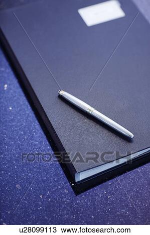 Stock Image - Folder and pen on office desk. Fotosearch