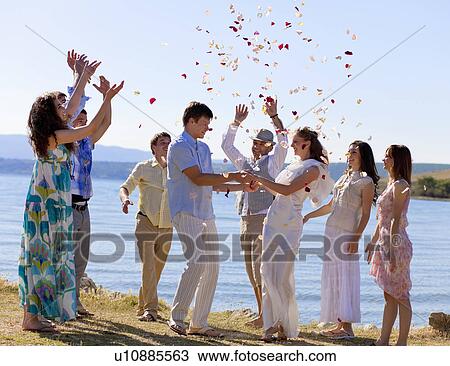 Stock Image - Friends celebrating newlywed couple. Fotosearch