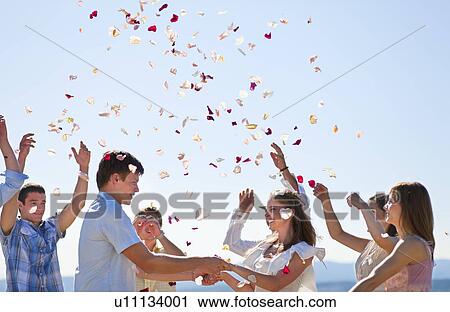 Stock Image - Friends celebrating newlywed couple. Fotosearch