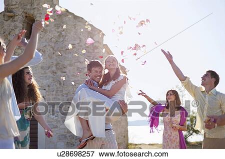 Stock Photo - Friends celebrating newlywed couple. Fotosearch