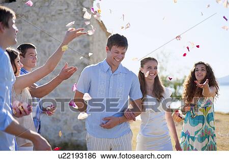 Stock Photograph - Friends celebrating newlywed couple. Fotosearch