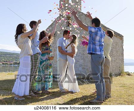 Stock Photograph - Friends celebrating newlywed couple. Fotosearch