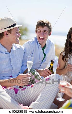 Friends drinking champagne outdoors View Large Photo Image Stock Photo - Friends drinking champagne outdoors. Fotosearch