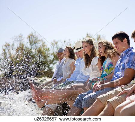 Friends kicking water from deck View Large Photo Image Stock Photo - Friends kicking water from deck. Fotosearch