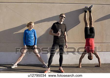 Picture - Friends talking after running together. Fotosearch