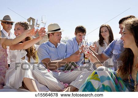 Stock Photo - Friends toasting newlywed couple. Fotosearch