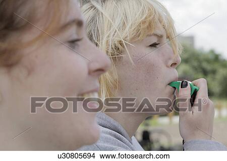 Girl blowing whistle outdoors View Large Photo Image Picture - Girl blowing whistle outdoors. Fotosearch