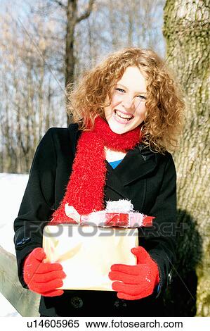 Girl carrying Christmas presents View Large Photo Image Stock Photography - Girl carrying Christmas presents. Fotosearch
