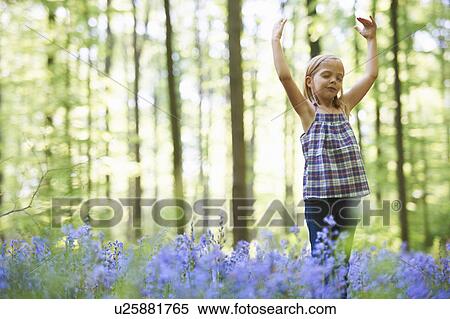 Girl dancing in field of flowers View Large Photo Image Stock Photography - Girl dancing in field of flowers. Fotosearch