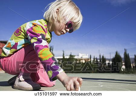 Girl drawing with sidewalk chalk View Large Photo Image Stock Photo - Girl drawing with sidewalk chalk. Fotosearch