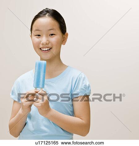 Girl eating a popsicle View Large Photo Image Stock Photography - Girl eating a popsicle. Fotosearch
