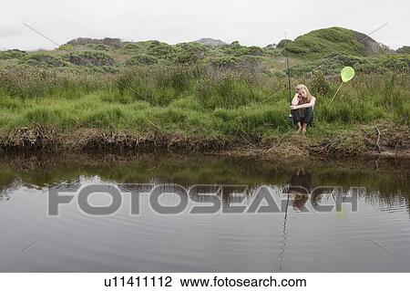 Girl fishing with net in creek View Large Photo Image Stock Image - Girl fishing with net in creek. Fotosearch