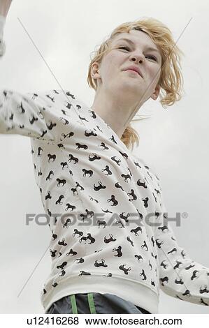 Stock Photo - Girl grimacing outdoors. Fotosearch