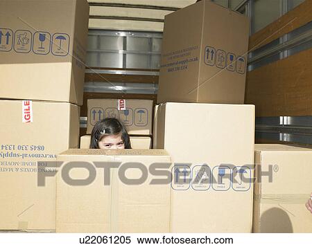 Girl hiding in boxes in moving van View Large Photo Image Stock Photography - Girl hiding in boxes in moving van. Fotosearch