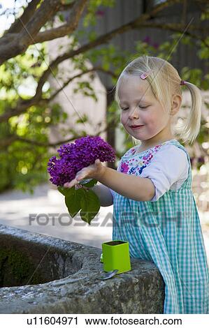 Girl holding bunch of flowers outdoors View Large Photo Image Stock Image - Girl holding bunch of flowers outdoors. Fotosearch