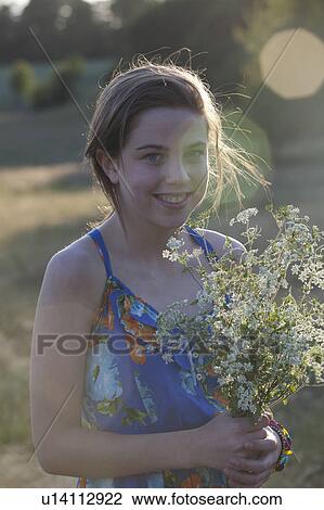 Girl holding bunch of flowers View Large Photo Image Stock Image - Girl holding bunch of flowers. Fotosearch