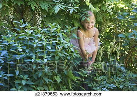 Girl in ballet costume hiding in bush View Large Photo Image Stock Image - Girl in ballet costume hiding in bush. Fotosearch