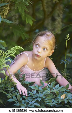 Girl in ballet costume hiding in bush View Large Photo Image Stock Photograph - Girl in ballet costume hiding in bush. Fotosearch