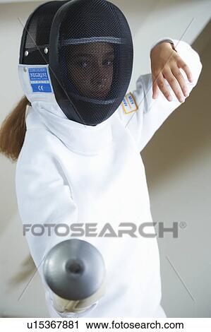 Stock Image - Girl in fencing costume holding sword. Fotosearch