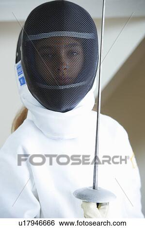 Stock Photograph - Girl in fencing costume holding sword. Fotosearch