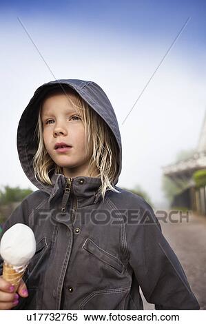 Girl in jacket eating ice cream cone View Large Photo Image Stock Photography - Girl in jacket eating ice cream cone. Fotosearch