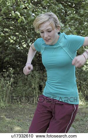 Stock Image - Girl jumping in park. Fotosearch