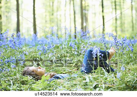 Girl laying in field of flowers View Large Photo Image Picture - Girl laying in field of flowers. Fotosearch
