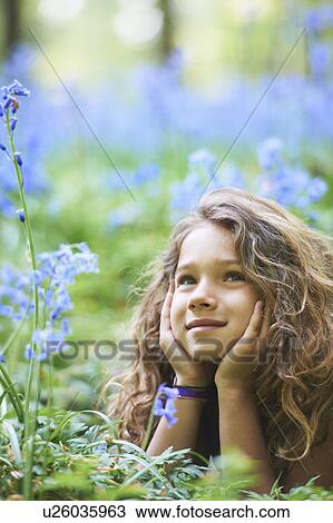 Girl laying in field of flowers View Large Photo Image Stock Image - Girl laying in field of flowers. Fotosearch