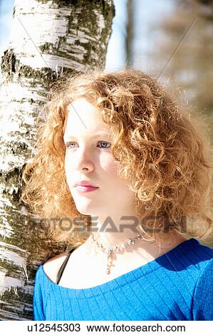 Girl leaning against tree View Large Photo Image Stock Image - Girl leaning against tree. Fotosearch