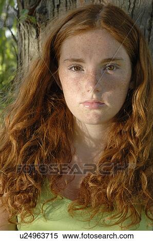 Stock Photography - Girl leaning against tree. Fotosearch