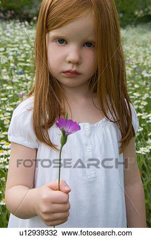 Girl picking flowers in field View Large Photo Image Stock Image - Girl picking flowers in field. Fotosearch