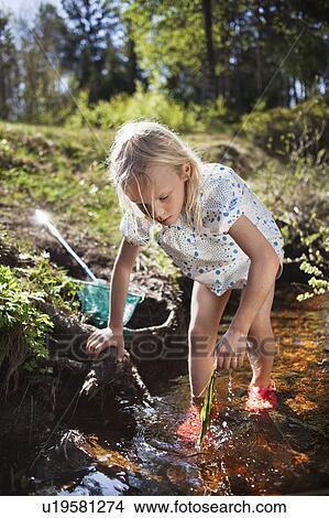 Girl playing in creek View Large Photo Image Picture - Girl playing in creek. Fotosearch