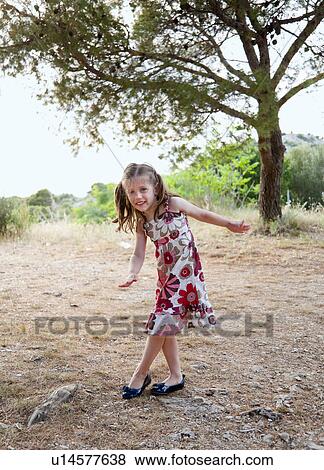 Girl playing outdoors View Large Photo Image Stock Photo - Girl playing outdoors. Fotosearch