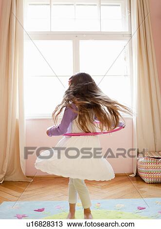 Girl playing with hula hoop View Large Photo Image Stock Image - Girl playing with hula hoop. Fotosearch
