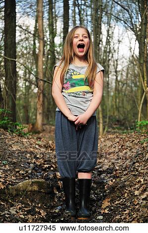 Stock Photography - Girl shouting in forest. Fotosearch