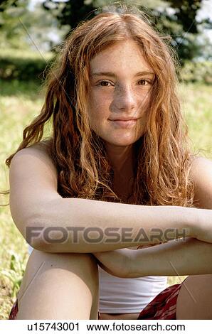 Girl sitting in grass in backyard View Large Photo Image Stock Image - Girl sitting in grass in backyard. Fotosearch