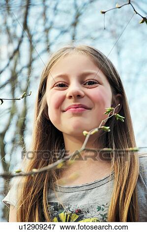 Stock Photo - Girl smiling outdoors. Fotosearch