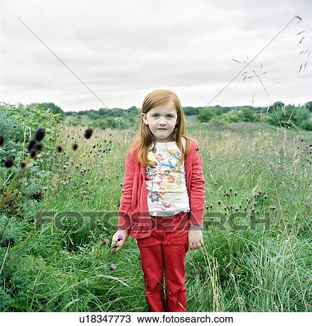 Girl standing in field of flowers View Large Photo Image Stock Image - Girl standing in field of flowers. Fotosearch