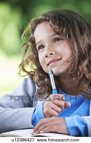 Girl thinking and writing View Large Photo Image Stock Photo - Girl thinking and writing. Fotosearch