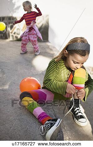 Girl tying her shoes View Large Photo Image Stock Photo - Girl tying her shoes. Fotosearch