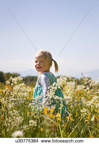 Girl walking in field of flowers View Large Photo Image Picture - Girl walking in field of flowers. Fotosearch