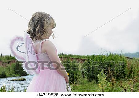 Stock Photograph - Girl wearing fairy costume by creek. Fotosearch