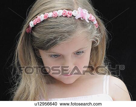 Stock Image - Girl wearing flower headband. Fotosearch